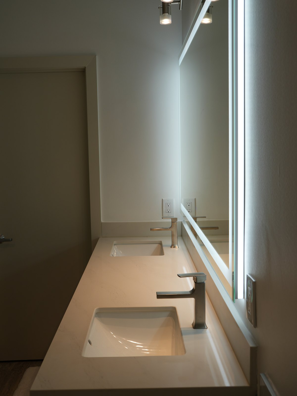 Bathroom remodel by Haven Renovations — long quartz vanity top with undermount sinks