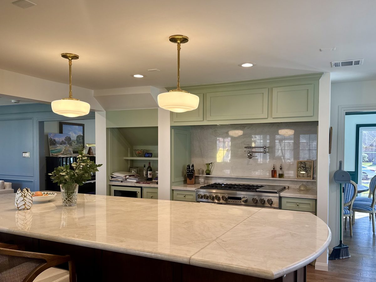 Custom kitchen by Haven Renovations — curved island, open to living