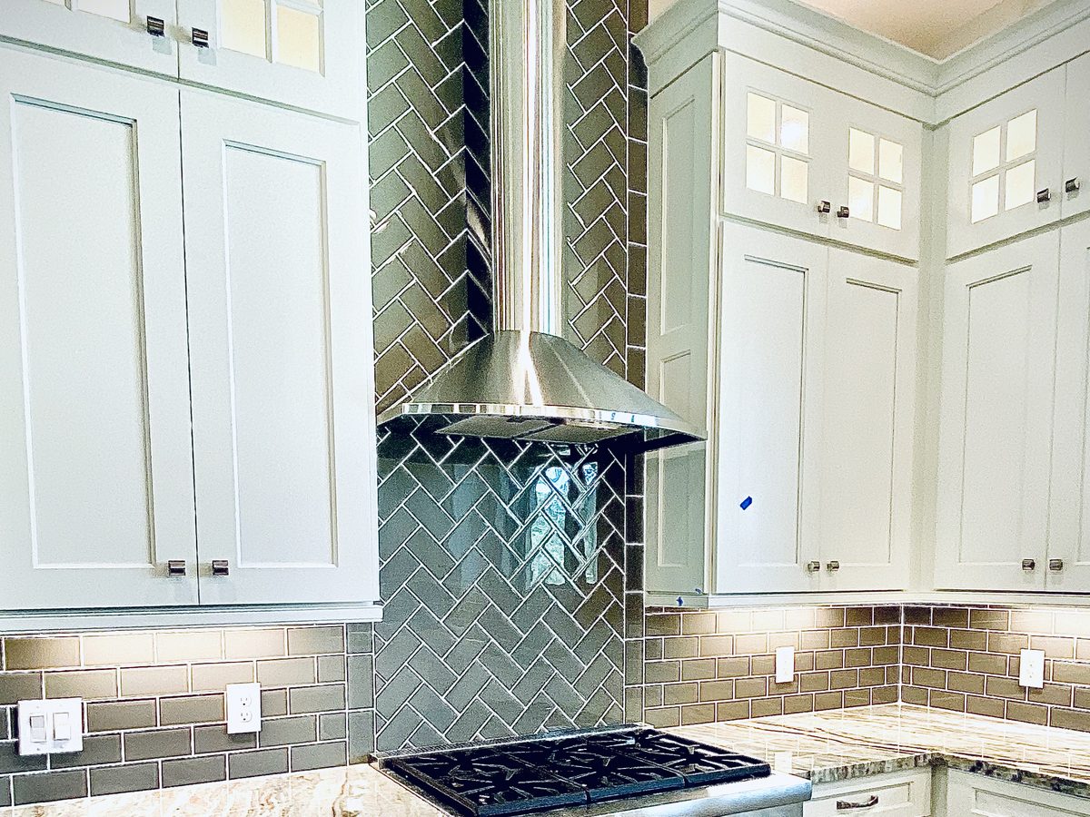 Custom kitchen by Haven Renovations — tile surround, professional range