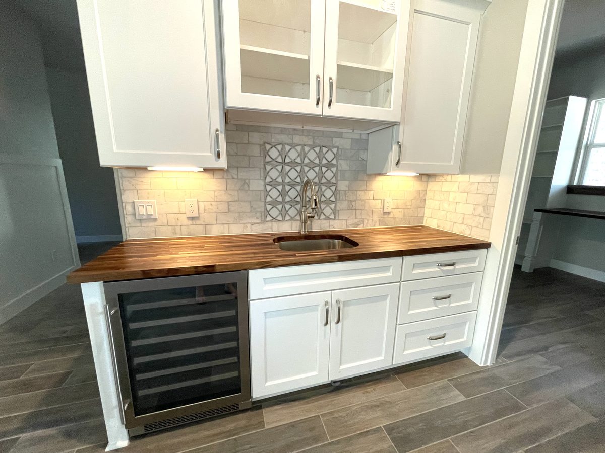 Custom kitchen by Haven Renovations — wine storage, patterned backsplash