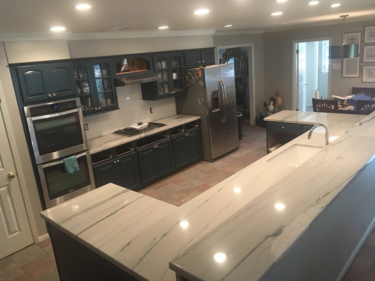 Custom kitchen by Haven Renovations — waterfall stone counters