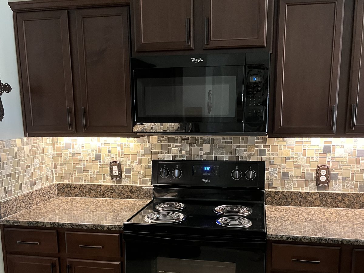 Custom kitchen by Haven Renovations — raised panel, stone counters