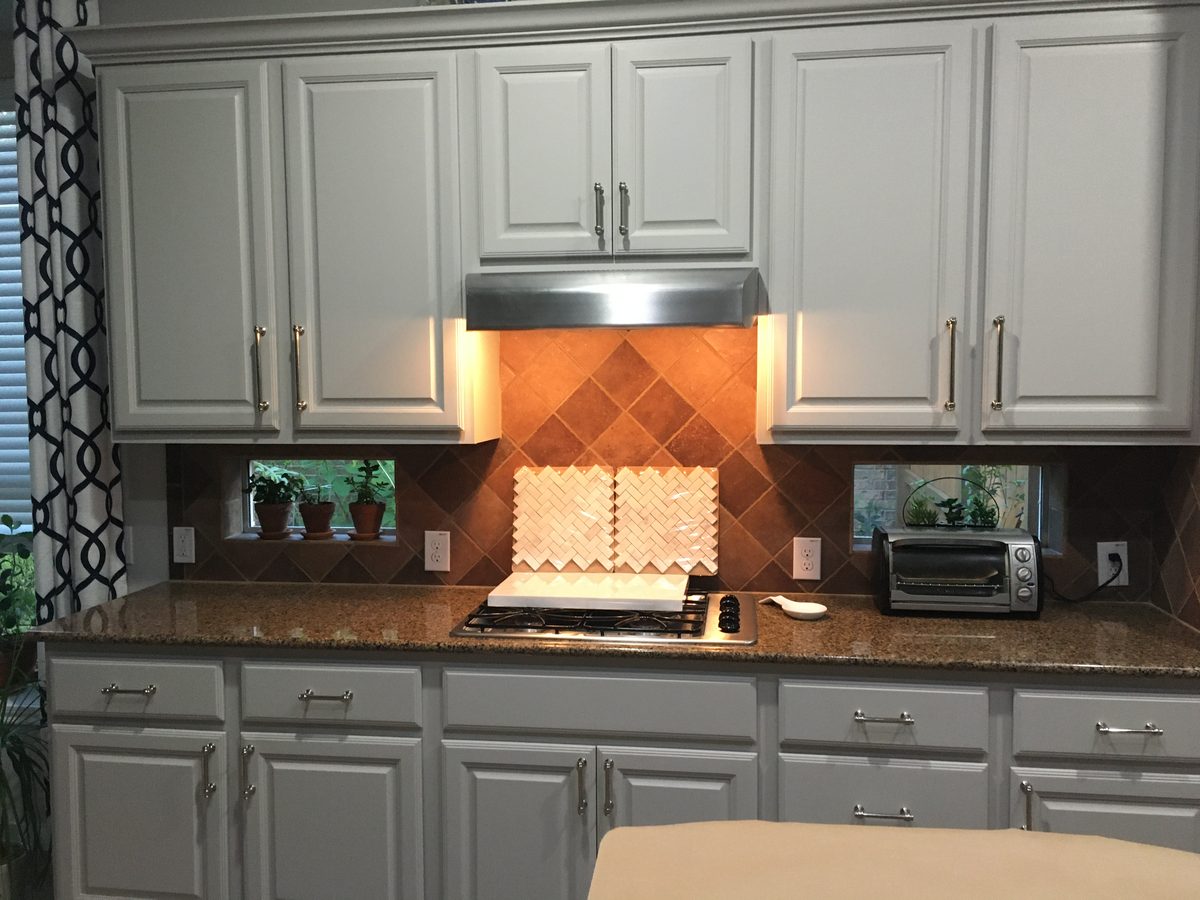 Custom kitchen by Haven Renovations — cream cabinetry, stone tops