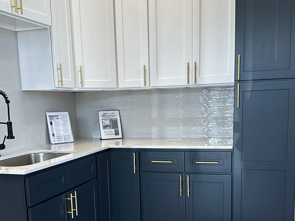 Custom kitchen by Haven Renovations — navy base, brass hardware
