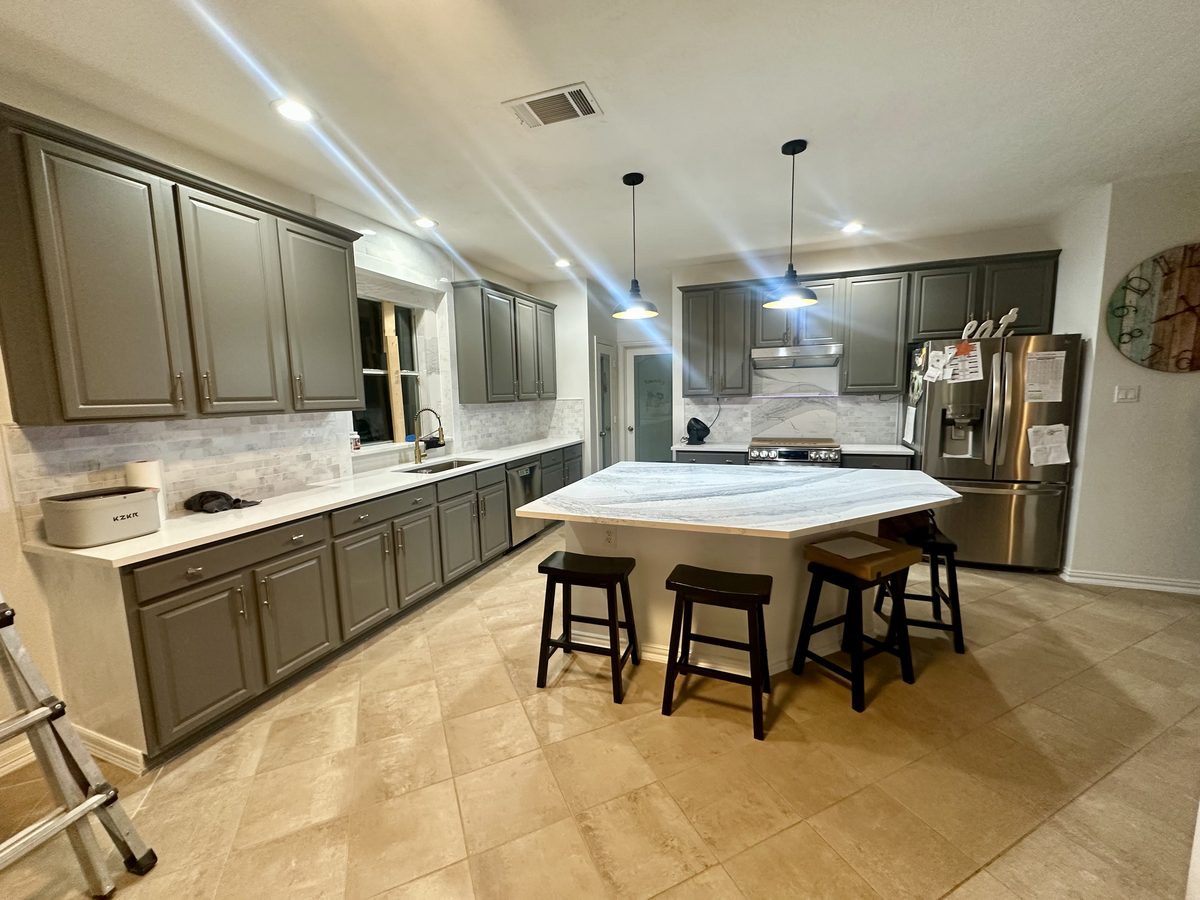 Custom kitchen by Haven Renovations — gray cabinetry, bar seating