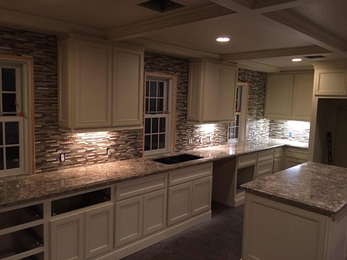 Custom kitchen by Haven Renovations — white cabinetry, island prep