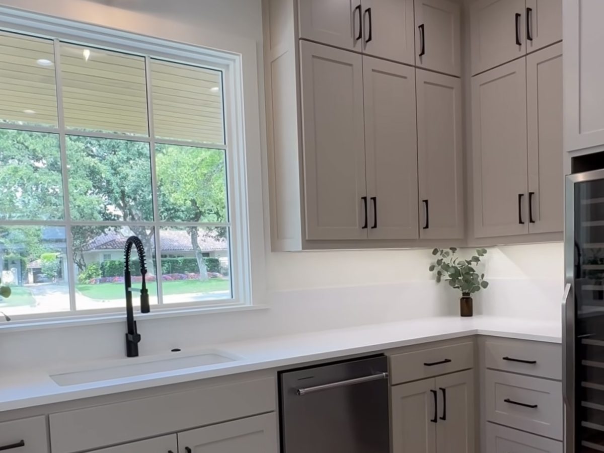 Custom kitchen by Haven Renovations — painted cabinetry, stone top
