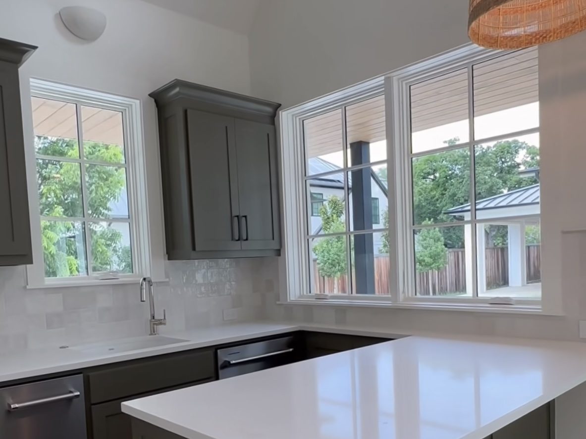 Custom kitchen by Haven Renovations — gray island, stone top