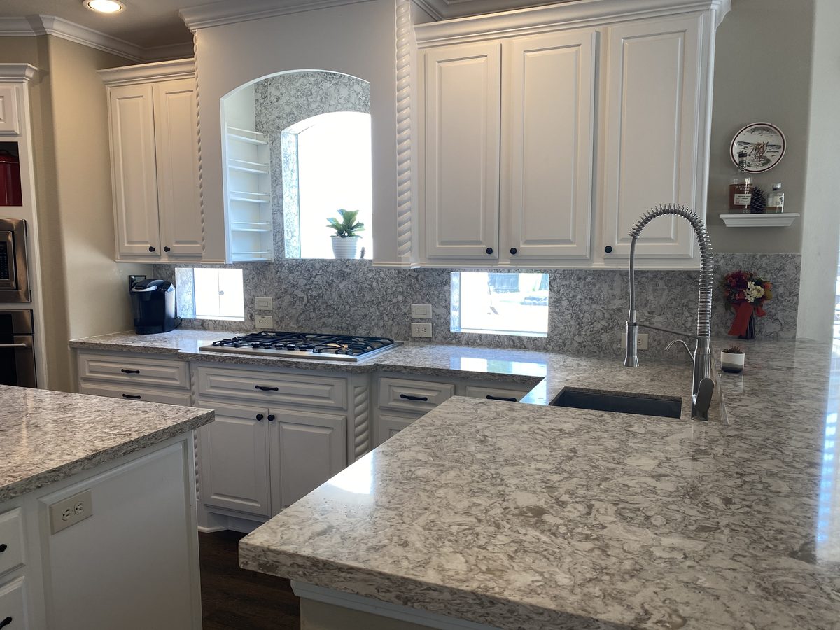 Custom kitchen by Haven Renovations — painted cabinetry, stone island