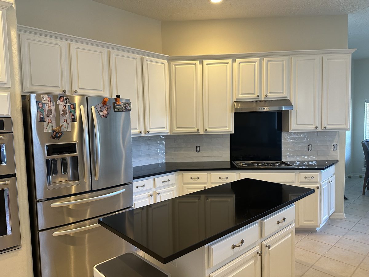 Custom kitchen by Haven Renovations — white cabinetry, stainless appliances