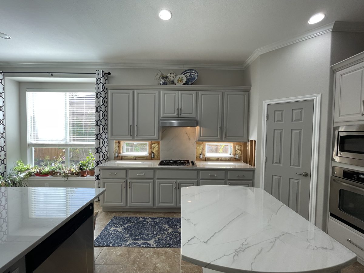 Custom kitchen by Haven Renovations — gray cabinetry, veined stone