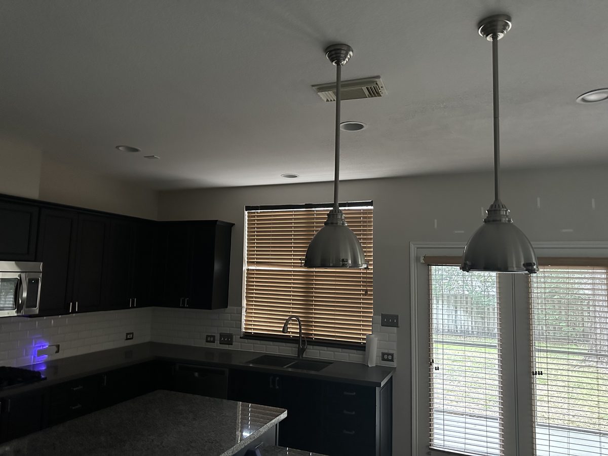 Custom kitchen by Haven Renovations — pendant lighting, stone tops