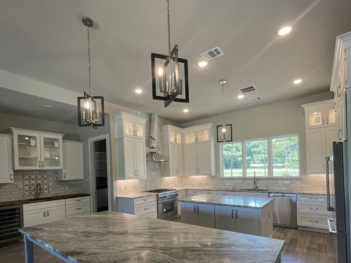 Custom kitchen by Haven Renovations — pendant lighting, stone top