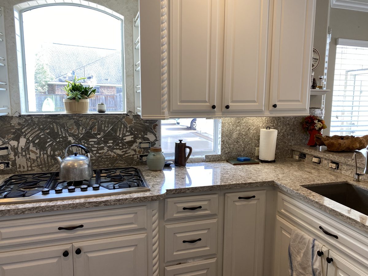 Custom kitchen by Haven Renovations — patterned backsplash, stone counters