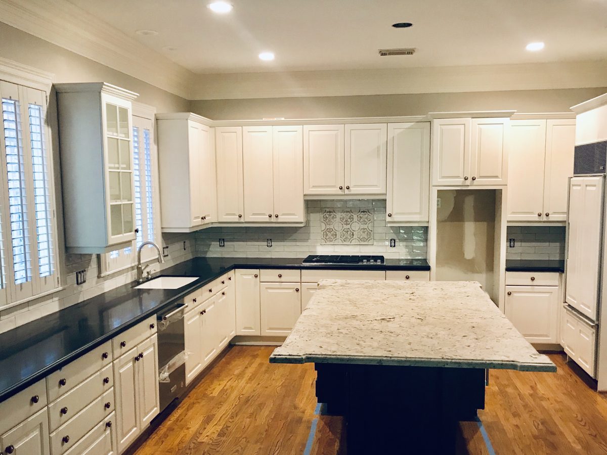 Custom kitchen by Haven Renovations — navy island, painted cabinetry