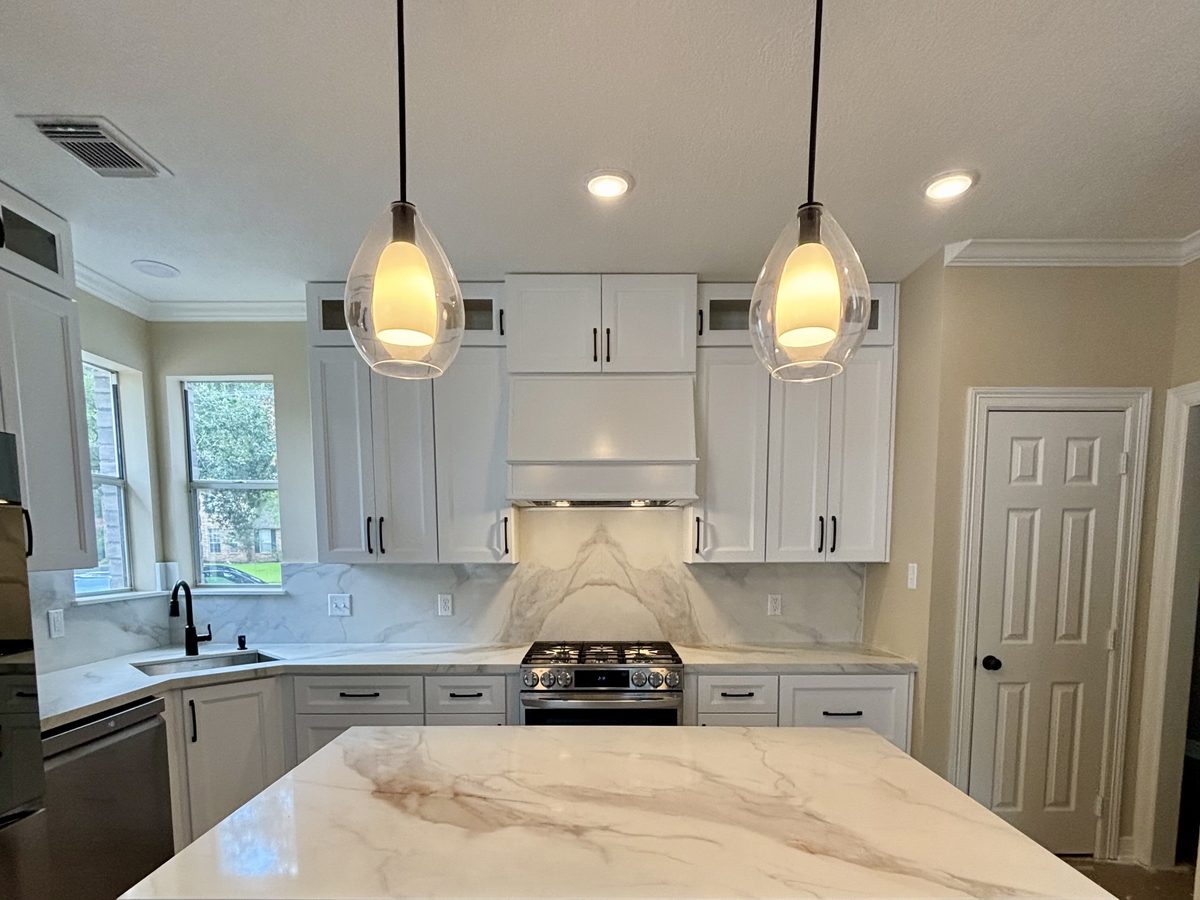 Custom kitchen by Haven Renovations — painted cabinetry, stone top