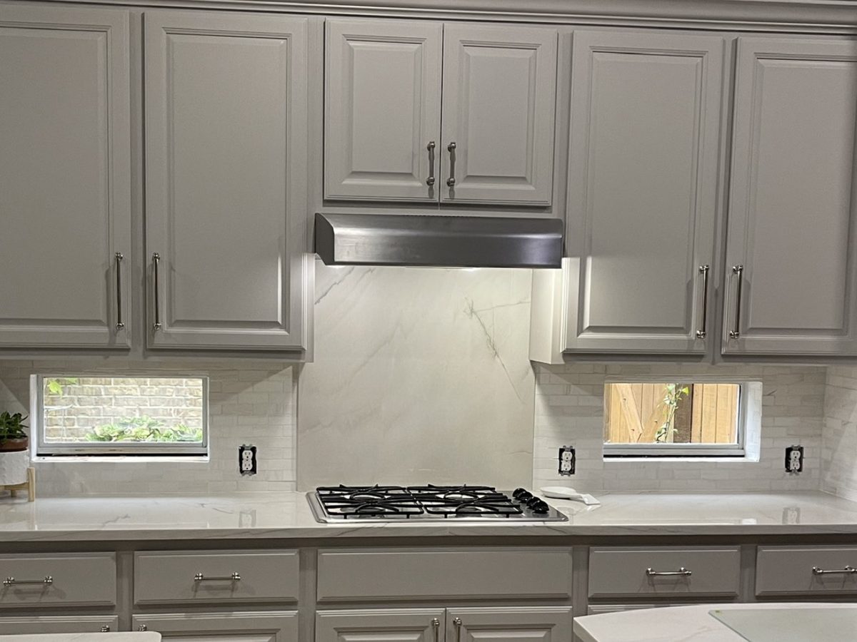 Custom kitchen by Haven Renovations — gray cabinetry, veined stone