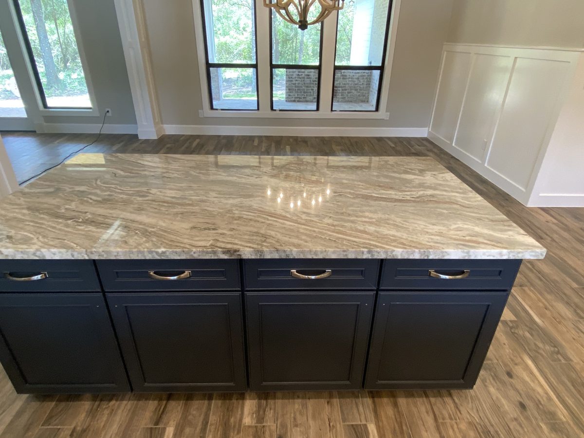 Custom kitchen by Haven Renovations — dark island with stone top