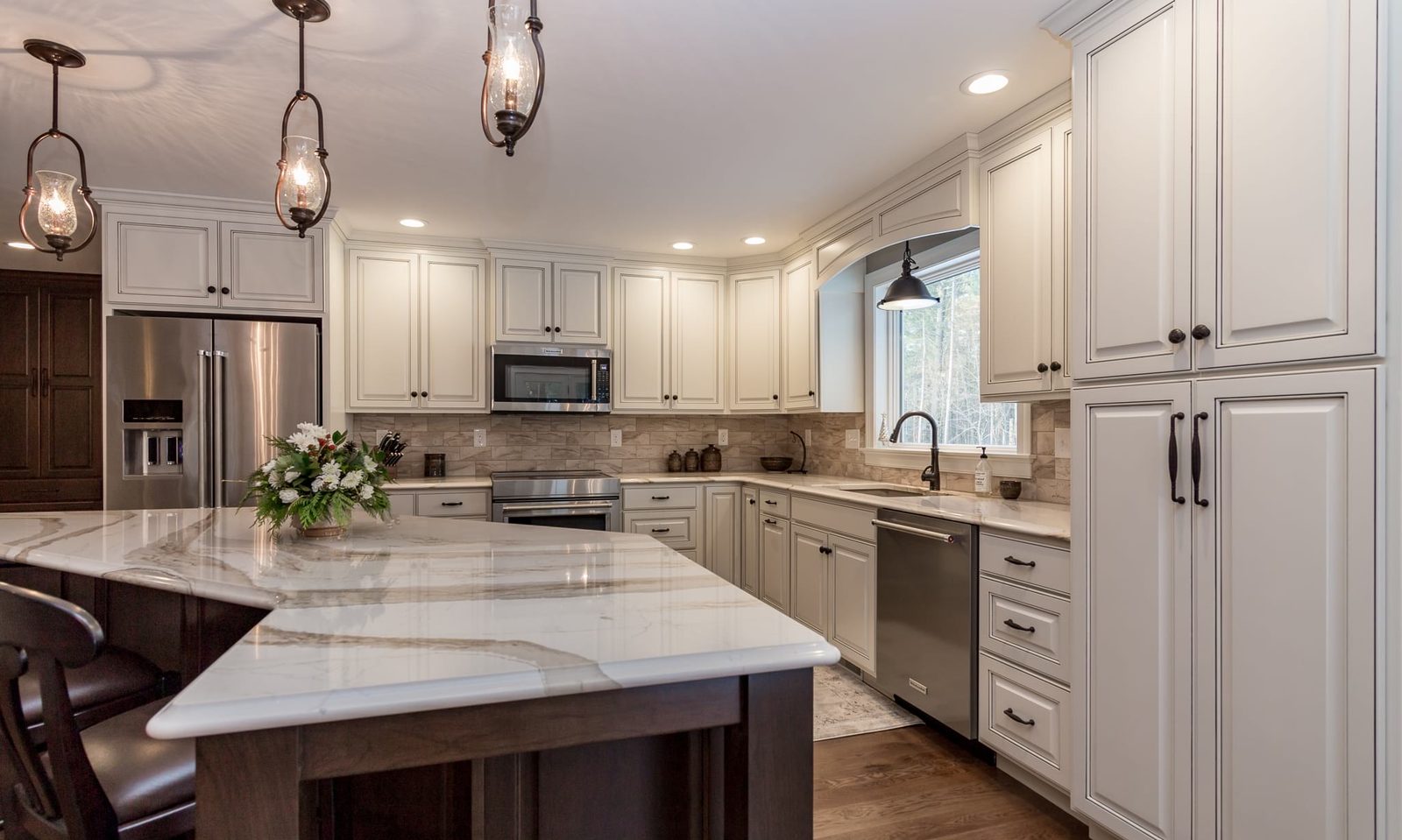 Custom kitchen by Haven Renovations — wood island with stone top