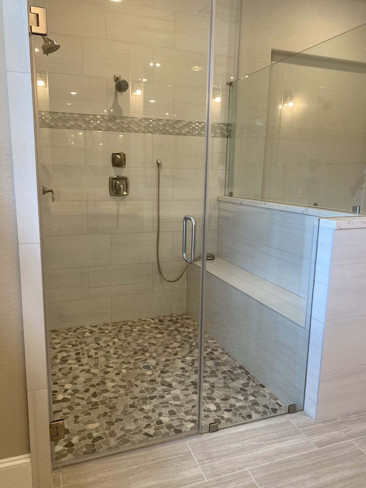 Pebble-floor shower with frameless glass door