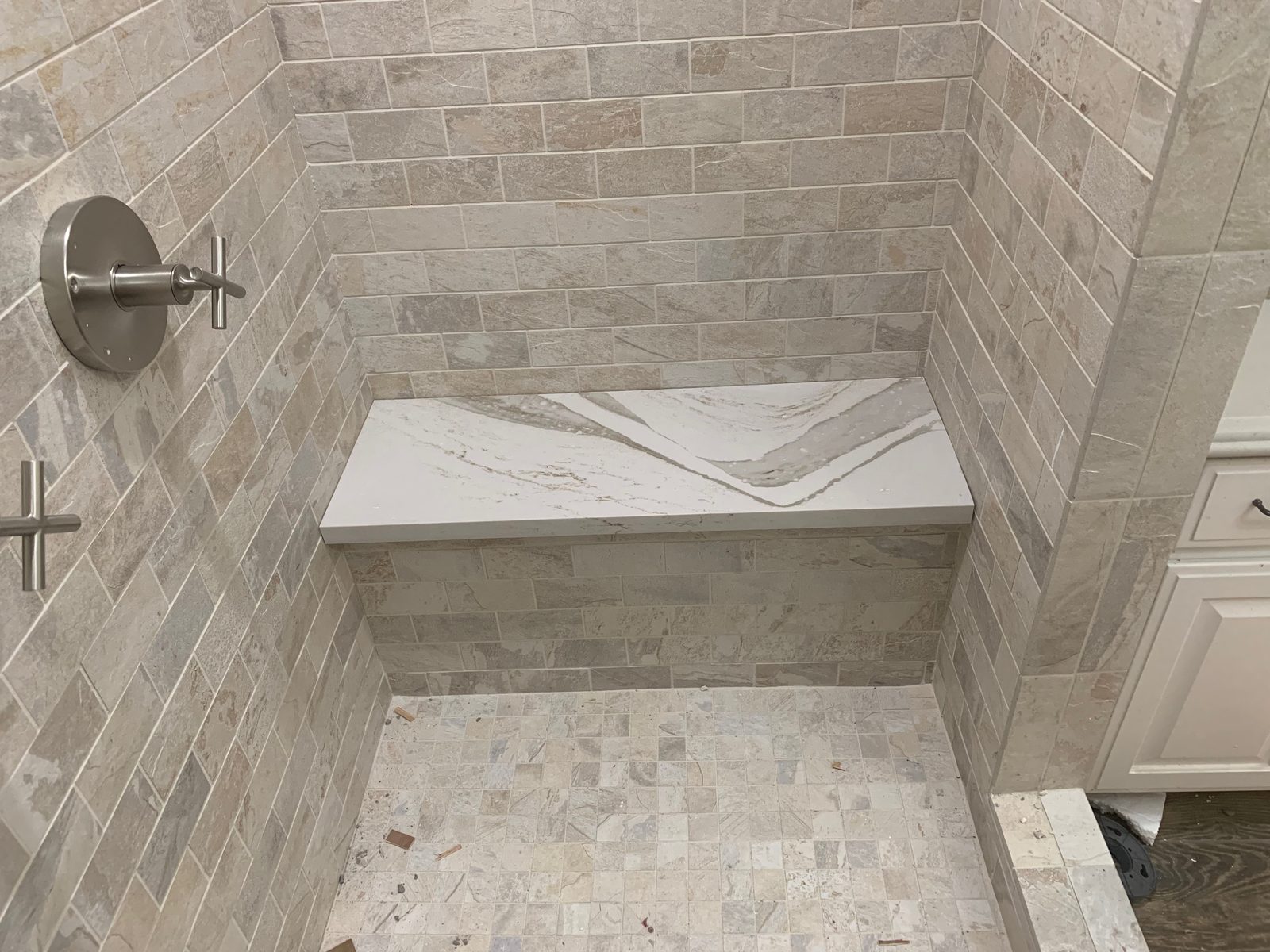 Quartz shower bench with subway tile surround