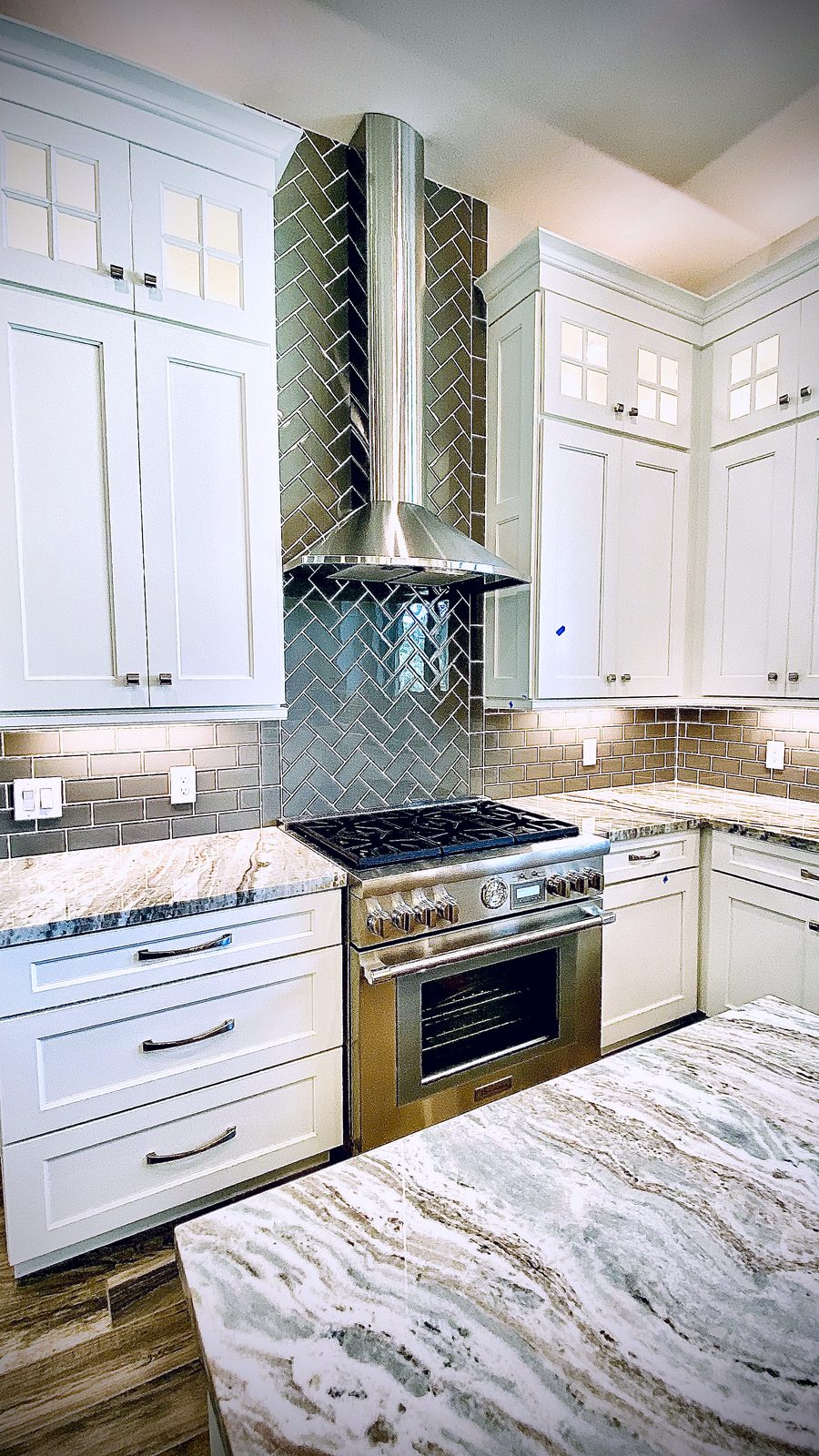 Custom kitchen by Haven Renovations — pro range, speckled granite