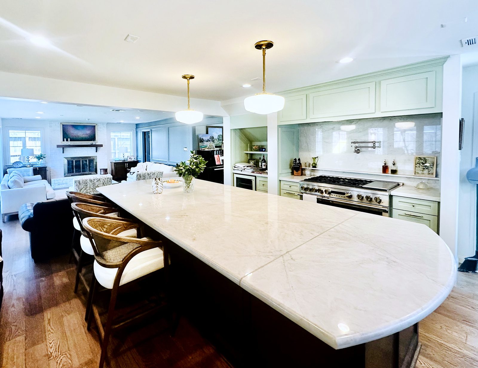 Custom kitchen by Haven Renovations — marble top, open to living