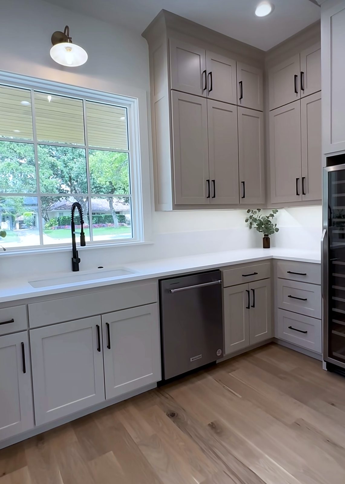 Custom kitchen by Haven Renovations — matte hardware, garden window