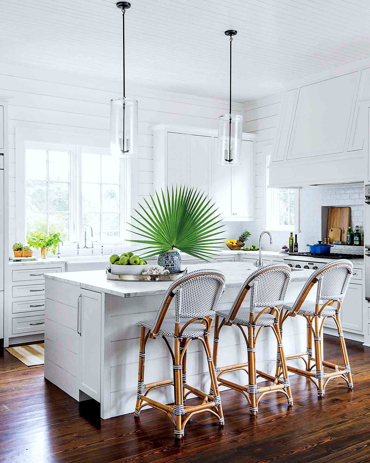 Custom kitchen by Haven Renovations — shiplap hood, rattan seating