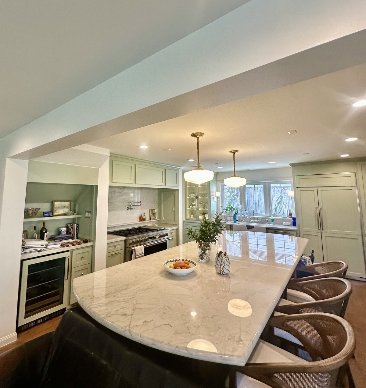 Custom kitchen by Haven Renovations — curved island with bar seating